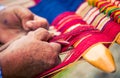 Hands weaving traditional blanket Chinchero