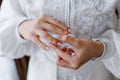 hands of the wedding bride puts on a ring.