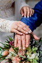 Hands with wedding gold rings happy newlyweds on a the bouquet background. Royalty Free Stock Photo