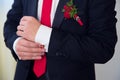 Hands of wedding groom getting ready in suit.