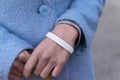 Hands with white bracelet