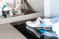 Hands in white glove cleaning induction stove in kitchen with spray bottle and rag Royalty Free Stock Photo