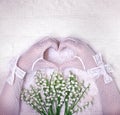 Hands in white wedding gloves in the shape of heart. Wedding con