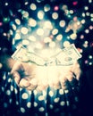 Hands of witch in a dark room conjuring a spell with US Dollar n Royalty Free Stock Photo