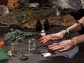 Hands witch. Transparent sphere. Magical objects and utensils of the alchemist. Candles, herbs. Concept - alternative medicine,