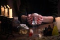 Hands witch. Transparent sphere. Magical objects and utensils of the alchemist. Candles, herbs. Concept - alternative medicine,