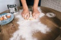 Hands of woman baker knead dough lump on table with flour on home cuisine.