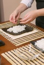 Hands of woman chef filling japanese sushi rolls Royalty Free Stock Photo