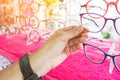 Hands of woman choosing new optical glasses in optician shop. Health care, Royalty Free Stock Photo