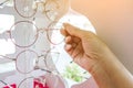 Hands of woman choosing new optical glasses in optician shop. Health care, Royalty Free Stock Photo