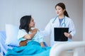 Hands woman doctor reassuring her female patient in hospital room,Doctor giving a consultation and encouragement to patient Royalty Free Stock Photo