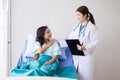 Hands woman doctor reassuring her female patient in hospital room,Doctor giving a consultation and encouragement to patient Royalty Free Stock Photo