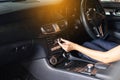 Hands woman driver turning on car air condition system,Button on dashboard in modern car panel,Auto car air conditioner Royalty Free Stock Photo