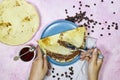 hands woman eating a Crepes stuffed with chocolate spread on blue plate with fig jam bowl and coffee beans Royalty Free Stock Photo