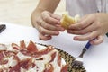 Hands of a woman while eats iberian ham