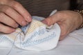 Woman`s hands embroider ornaments