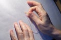 Hands of a woman embroidering a talisman for a child Royalty Free Stock Photo