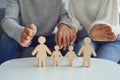 In the hands of a woman is a family of wooden figures. Family Planning Protection Concept Royalty Free Stock Photo