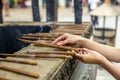 Hands of a woman holding burning incense sticks in the Jing'an temple in Shanghai Royalty Free Stock Photo