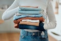 hands of a woman holding a pile of laundry. Woman holding a stack of neat, folded laundry. Woman cleaning clothing at Royalty Free Stock Photo