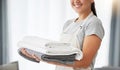 Hands of a woman holding a pile of laundry. Woman holding a stack of neat, folded laundry. Woman cleaning clothing at Royalty Free Stock Photo