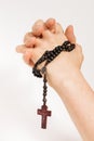 hands of a woman holding a rosary and praying Royalty Free Stock Photo