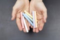 Hands of a woman holding some colored chalks Royalty Free Stock Photo