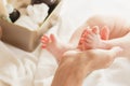 Hands of woman holds baby feet Royalty Free Stock Photo