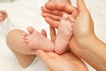 Hands of woman holds baby, blurred background Royalty Free Stock Photo