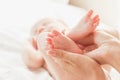 Hands of woman holds baby feet Royalty Free Stock Photo