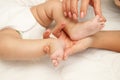 Hands of woman holds baby feet, blurred background Royalty Free Stock Photo