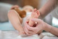 hands woman holds baby feet soft focus background Royalty Free Stock Photo