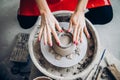 Hands of woman make clay dishes on potter wheel, Top view. Concept elegance Royalty Free Stock Photo