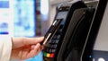 Hands of a woman making a payment using a credit card terminal, Royalty Free Stock Photo