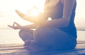 Hands of woman meditating on a yoga pose on the beach Royalty Free Stock Photo