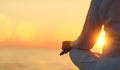 Hands of woman meditating in yoga pose at sunset on beach Royalty Free Stock Photo