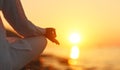 Hands of woman meditating in yoga pose at sunset on beach Royalty Free Stock Photo