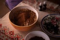 Hands of a woman mixing ground walnut with cocoa, raisins and Turkish delicacies in the kitchen. preparing a traditional cake reci