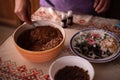 Hands of a woman mixing ground walnut with cocoa, raisins and Turkish delicacies in the kitchen. preparing a traditional cake reci