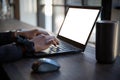 Hands of a woman in the office working on laptop, blank screen with mock up Royalty Free Stock Photo