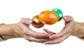 Hands of a woman perform a magic trick with the colorful Easter egg