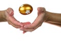 Hands of a woman perform a magic trick with the golden Easter egg