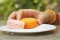 Hands of the woman picked a macaron