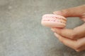 Hands of the woman picked a macaron