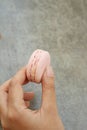 Hands of the woman picked a macaron