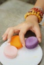 Hands of the woman picked a macaron