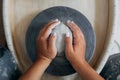 Hands of woman potter, ready to work with white clay at pottery wheel Royalty Free Stock Photo