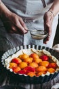 Hands of a woman preparing an apricot pie Royalty Free Stock Photo