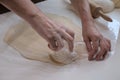 Hands of a woman in process of making small rouds from dough Royalty Free Stock Photo
