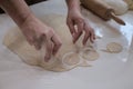 Hands of a woman in process of making small rouds from dough Royalty Free Stock Photo